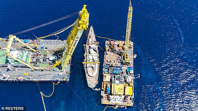 A drone's eye view of the Bayesian being raised from the water by salvage crews