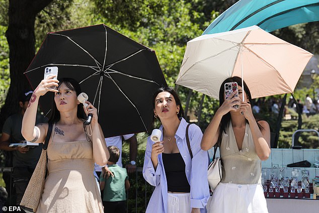 Tourists attempt to deal with the heat in Barcelona on June 28 as a new Spanish high temperature record for June of 46C is confirmed