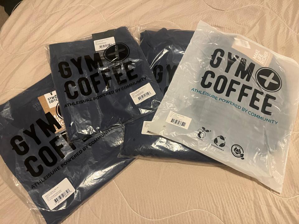 Three Gym Coffee athleisure items in plastic packaging.
