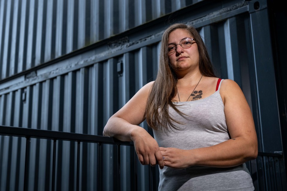 Photo of Katie O'Brien standing outside her shipping container home.