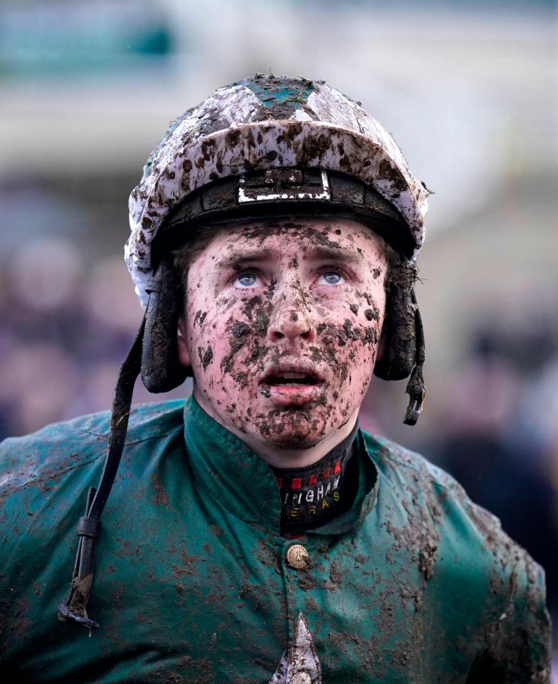 Mud-covered jockey after a race.