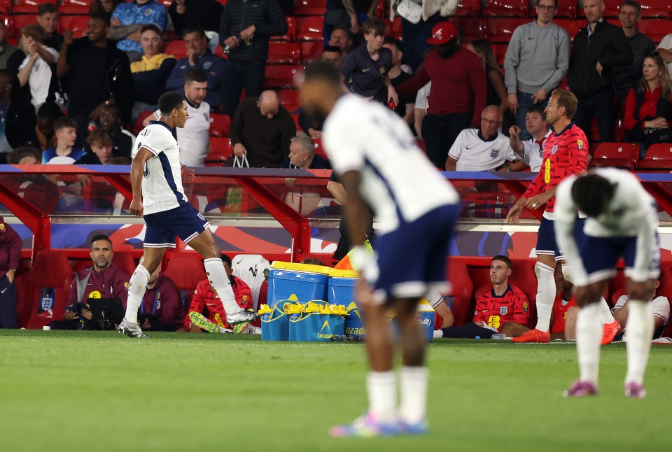Soccer players on the sidelines during a game.