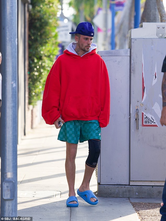 Justin Bieber revealed his striking weight loss as well as a mystery injury as he stepped out in Hollywood on Friday