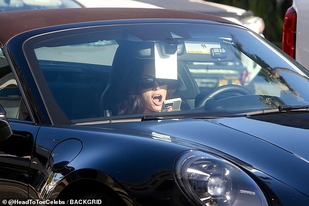 Kanye West's wife Bianca Censori has pulled yet another stunt certain to leave the public in a state of astonishment - staring at her phone while driving her Porsche in Beverly Hills