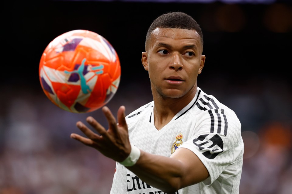 Kylian Mbappé, Real Madrid forward, controls a soccer ball.