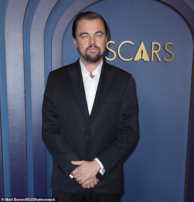 The Oscar winner, 50, is known for his trademark baseball cap but took the look to a new extreme at the wedding festivities as he pulled the hat comically down over his eyes while stepping out - pictured hatless in 2024