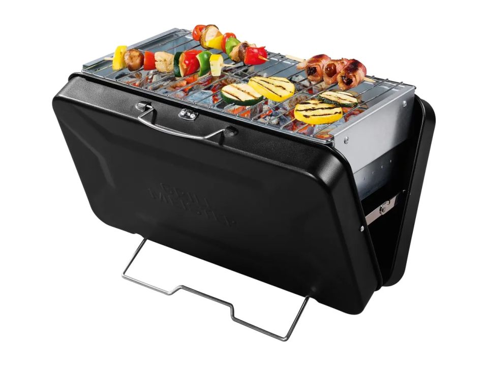 Foldable barbecue grill with food cooking on it.