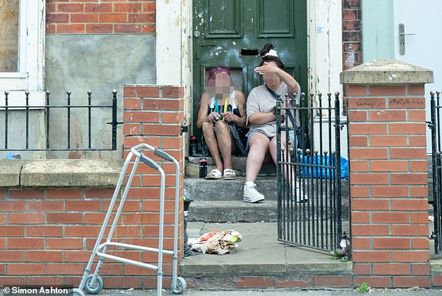 Local residents on Harlington Road, Stockton-on-Tees sit outside their front door