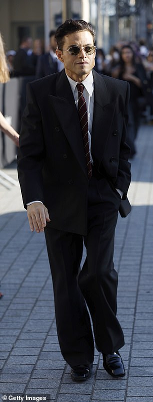 Rami Malek also attended the show as he put on a dapper display in a black suit despite the sunny weather