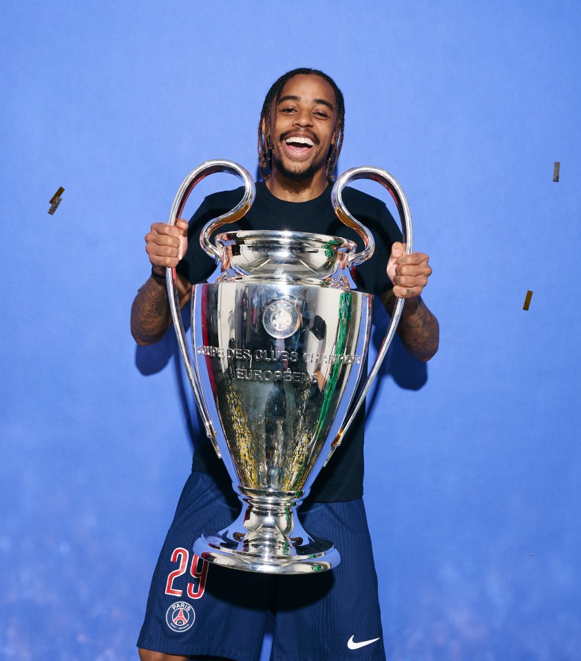 Bradley Barcola of Paris Saint-Germain holding the UEFA Champions League trophy.