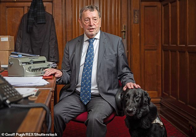 Lord Blunkett (pictured with his guide dog) warned Sir Keir Starmer will be forced to hold a 'humiliating vote of confidence in his own Government if he loses to Labour's welfare rebels