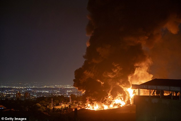 Los Angeles cops have scrambled to delete a bizarre social media post about the conflict in Iran after it was widely slammed as 'embarrassing' and 'offensive'. (Pictured: Fire and smoke rise into the sky after an Israeli attack on the Shahran oil depot on June 15, 2025 in Tehran)