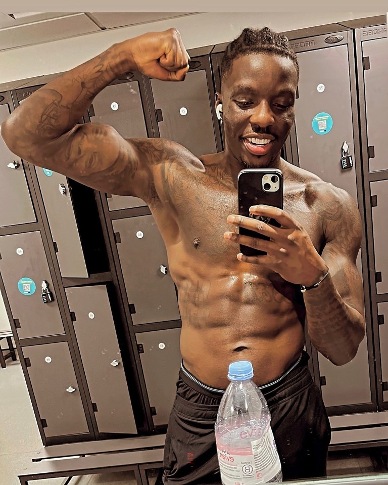 Man flexing in front of lockers.