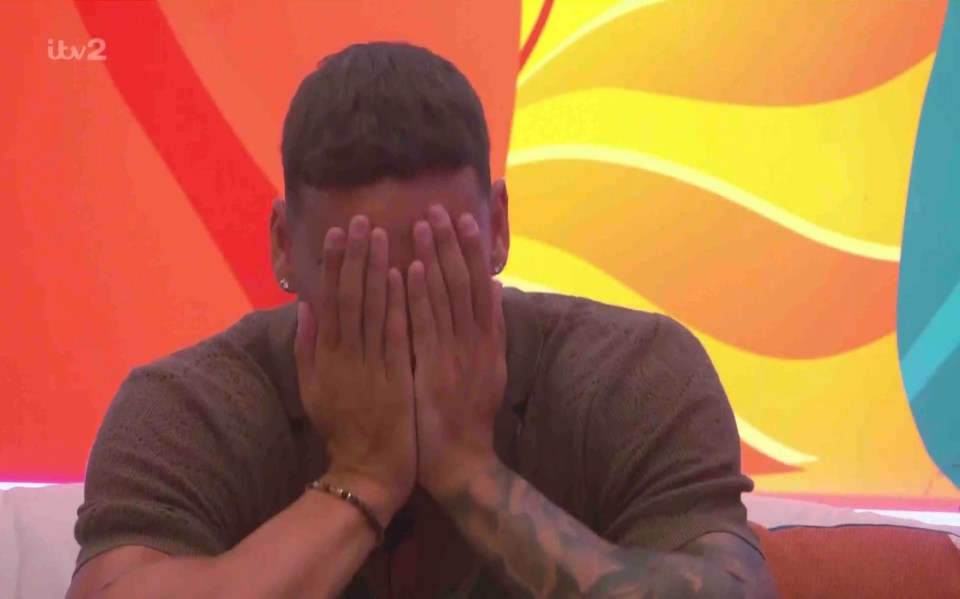 Man covering his face with his hands.