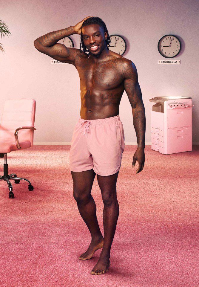 Portrait of a shirtless man in pink shorts.