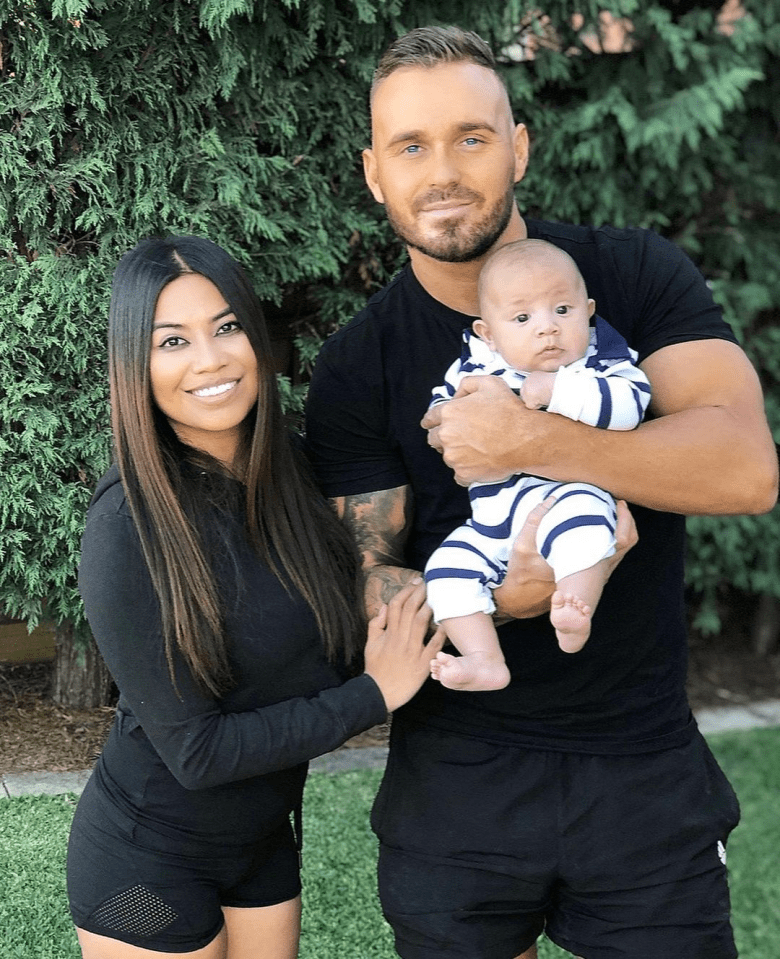 Family portrait of a man, woman, and baby.
