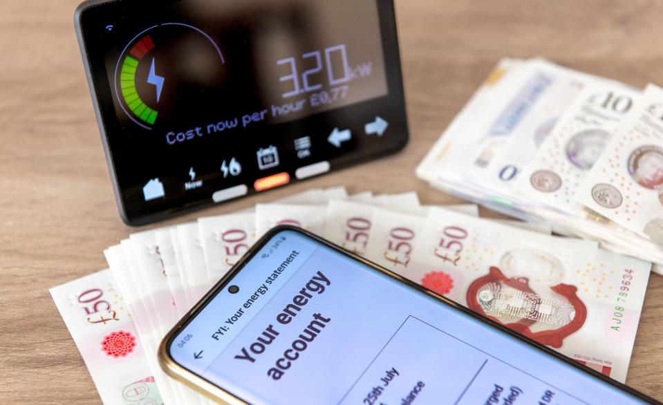 Smartphone displaying energy bill, smart meter, and cash.