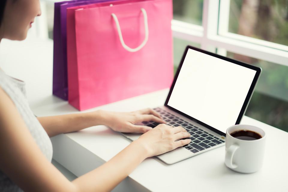 Woman shopping online at a coffee shop.