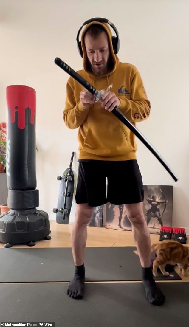 Marcus Arduini Monzo, 37, allegedly skinned and deboned his pet cat before launching a 20-minute spree of violence in Hainault, east London, while high on cannabis, the Old Bailey heard. Pictured: Marcus Arduini Monzo with a samurai sword