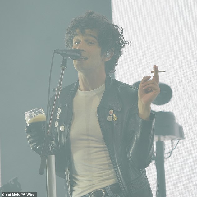 Matty Healy smoked a cigarette and drank a pint of Guinness as he took to the stage for The 1975's Glastonbury headliner set