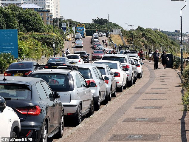 Cars parked all along the road on the East Cliff in Bournemouth. The mayor of the seaside town has condemned his own council over proposals to charge residents £70 to park