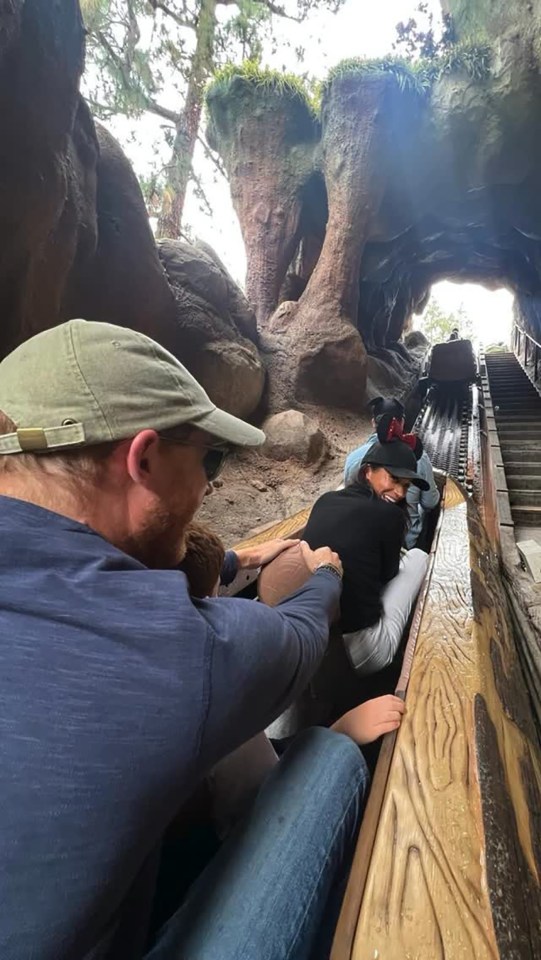 Meghan Markle and Prince Harry with their children on a Disneyland ride.