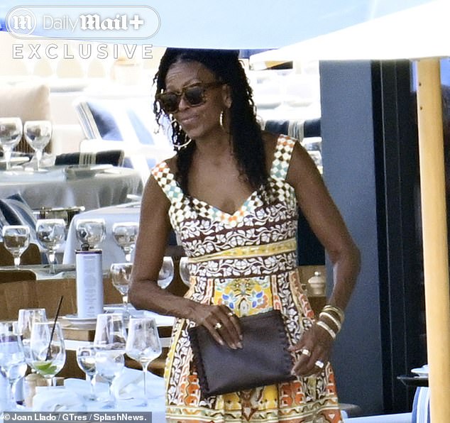 In photos obtained exclusively by the Daily Mail, the former first lady, 61, kept a low profile in large, stylish sunglasses and a multi-colored print dress, while dining at The Lobster Club in Puerto Portals.