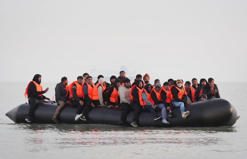 Migrants in a small boat crossing the English Channel.