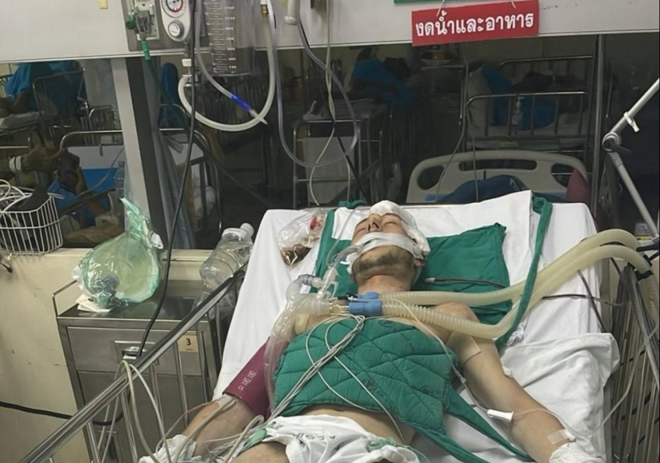 Man on life support in a hospital bed.