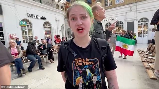 The activist, seen wearing an X-Files T-shirt, was seen inside Brighton train station describing Israel 's invasion of Gaza as the 'third Holocaust'