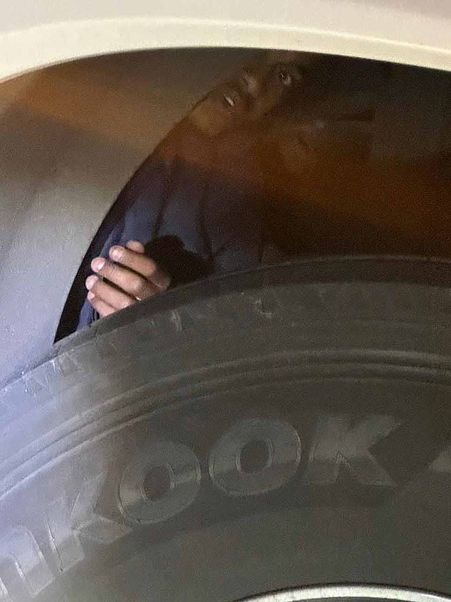 The extraordinary moment a migrant was discovered under the wheel arch, behind the tyre, of a coach full of British schoolchildren returning from France