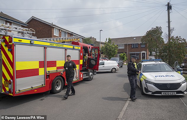 Emergency services at the scene on Russell Close in Heckmondwike, West Yorkshire, where a man and a nine-year-old girl died in a house fire
