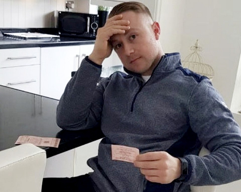 Man looking disappointed at his lottery ticket.