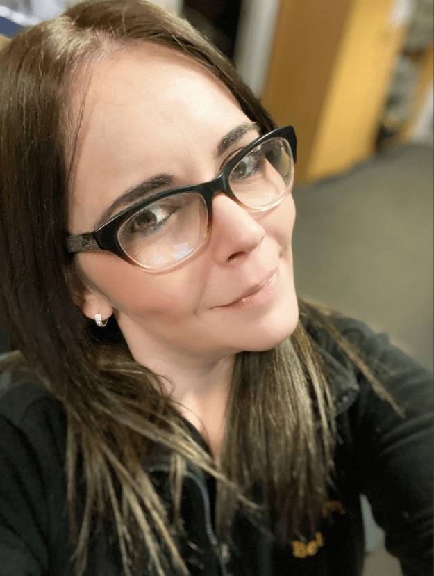 Close-up of a woman wearing glasses.