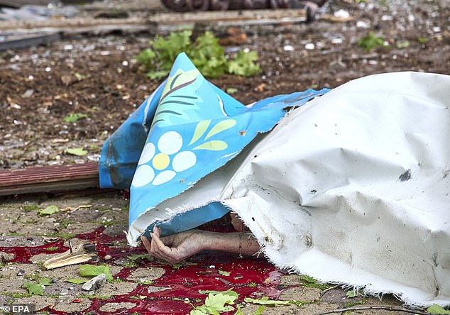 The covered body of a woman killed at the site where a Russian bomb hit the Children's Railway, in Kharkiv, Ukraine, 07 June 2025