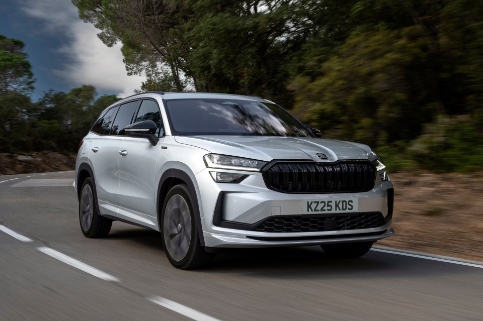 Silver SUV driving on a winding road.