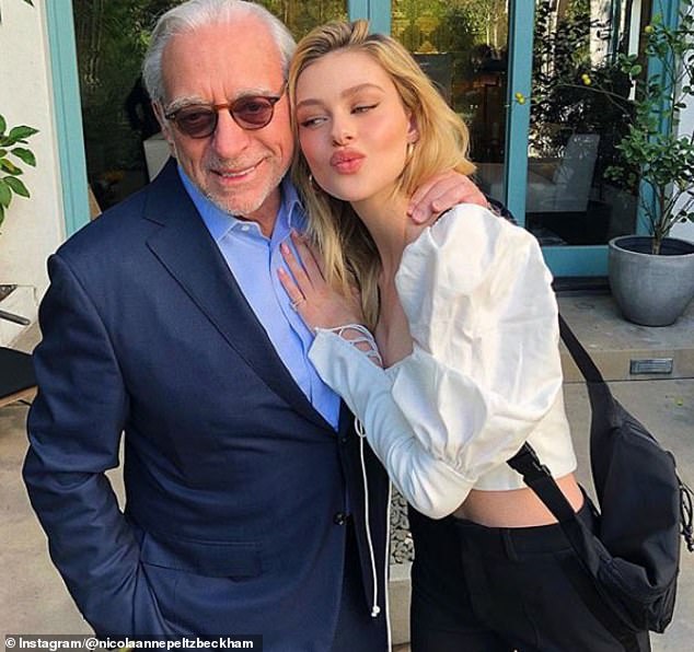Nicola Peltz and husband Brooklyn Beckham continued to celebrate her billionaire father Nelson's 83rd birthday with a party on Sunday (Nicola and Nelson pictured together last year)
