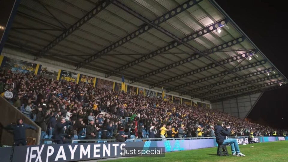 A packed stadium of cheering fans.