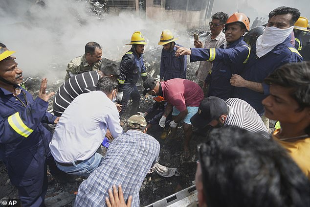 Rescuers work at the site of an airplane that crashed in India's northwestern city of Ahmedabad in Gujarat state, Thursday, June12, 2025