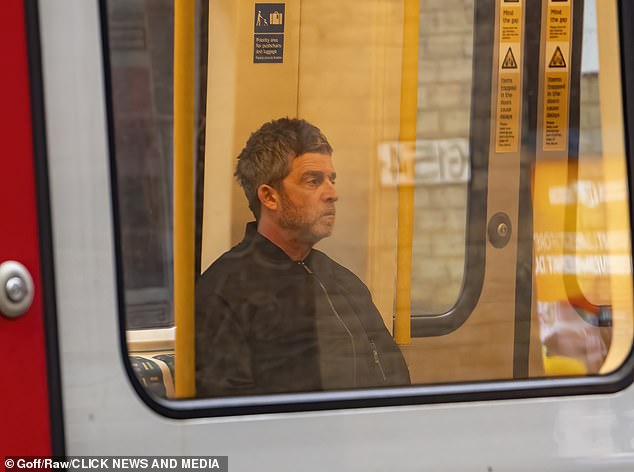 Noel Gallagher looked distinctly stony-faced as he made a lonely journey on the District line tube to join brother Liam for Oasis rehearsals on Tuesday