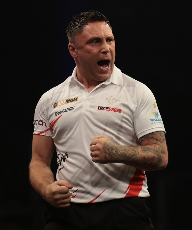 Gerwyn Price of Wales celebrates at a darts competition.