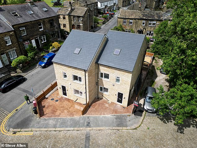 Neighbours will ¿buy popcorn¿ and watch from their windows if bulldozers move in to tear down two huge homes, pictured ¿ after it emerged they were built without planning permission