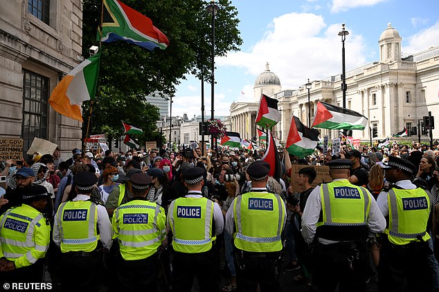 Police officers line up in front of pro-Palestine protesters who gathered in Trafalgar Square