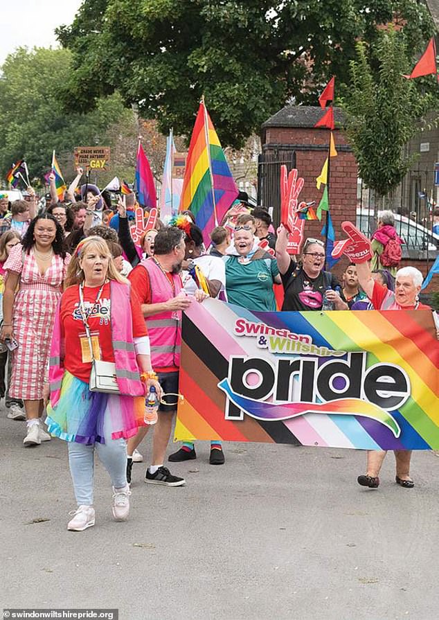 Parents were left fuming after finding out their primary aged children are being taught about the 300 different flags of pride at school. Pictured: Swindon and Wiltshire Pride supporters on a march