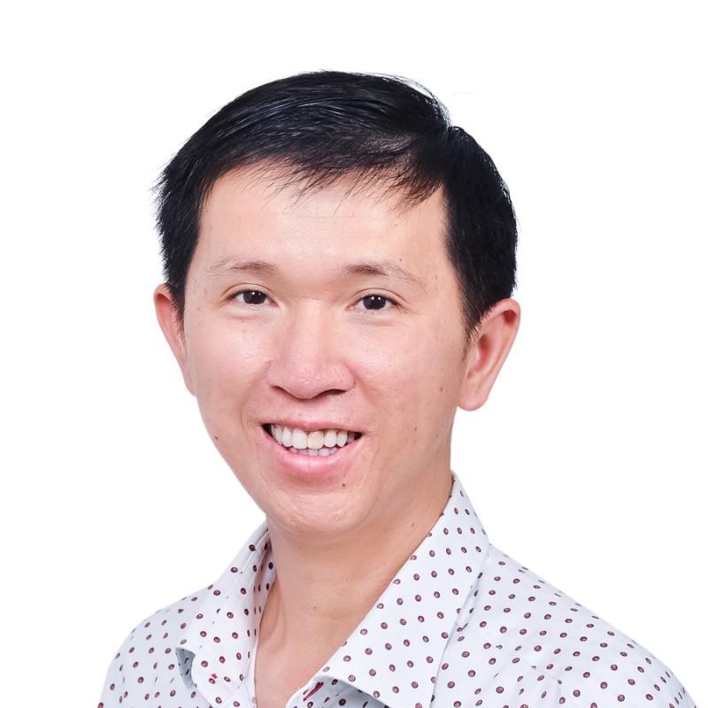 Headshot of a smiling man.