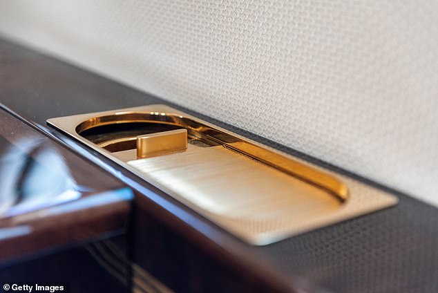 The FAA believe it's better to have a designated place to extinguish a cigarette than risk a smoker tossing it into a trash bin full of paper towels and flammable waste. Pictured: a golden ashtray in a first class cabin
