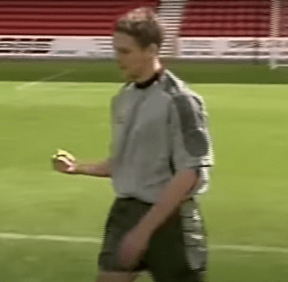 Soccer player holding a yellow card.