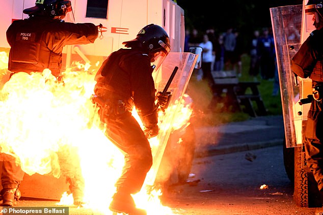 One cop was seen engulfed in flames after facing attacks from an anti-immigration mob