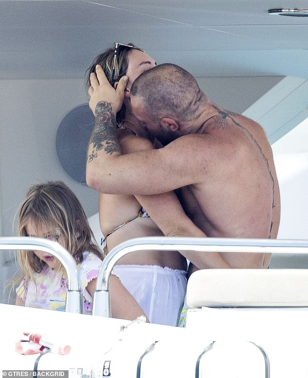 Conor McGregor got frisky with fiance Dee Devlin as he was seen for the first time since a 6am Ibiza nightclub attack