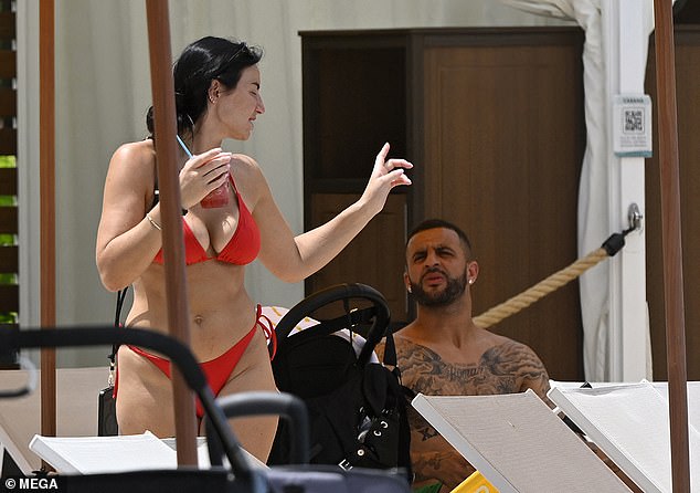 Annie Kilner, 32, showing off her stunning figure in a red bikini as she sipped an iced drink next to Kyle Walker, 34, at the Orlando theme park resort